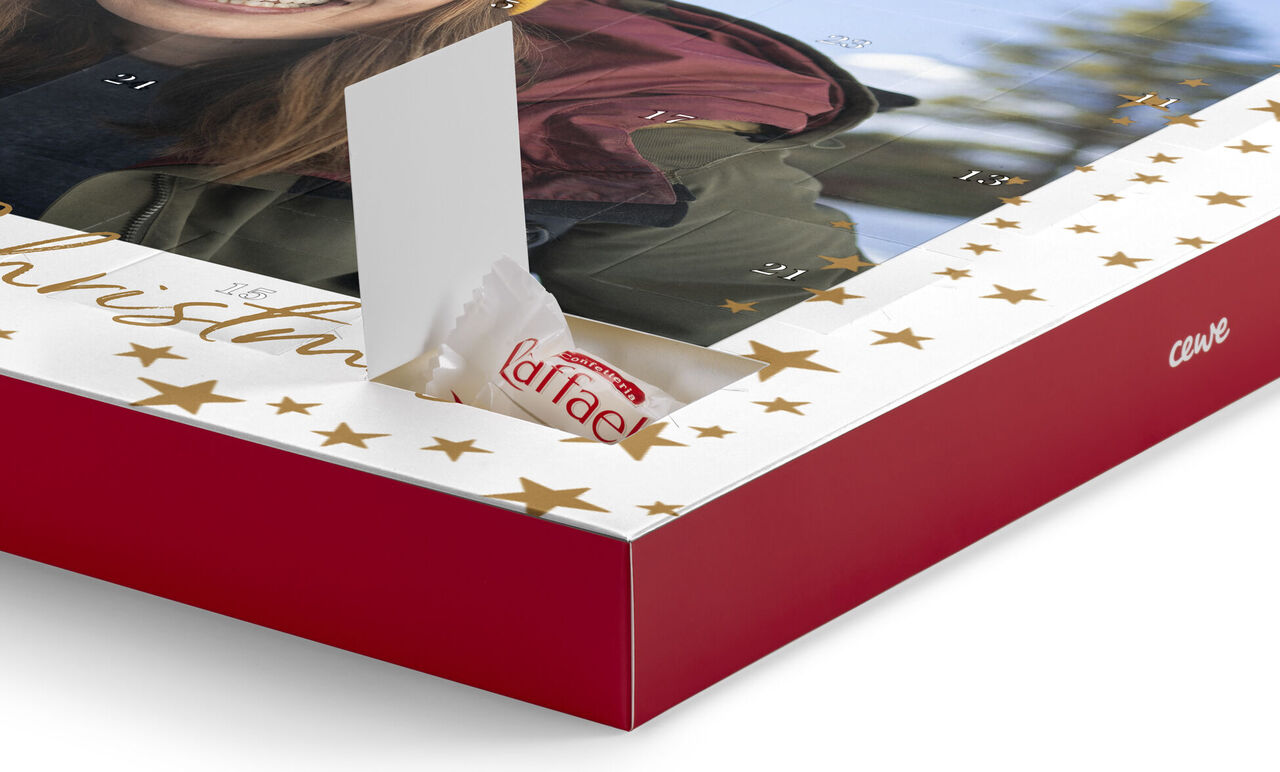 An advent calendar with a photo and a piece of chocolate.