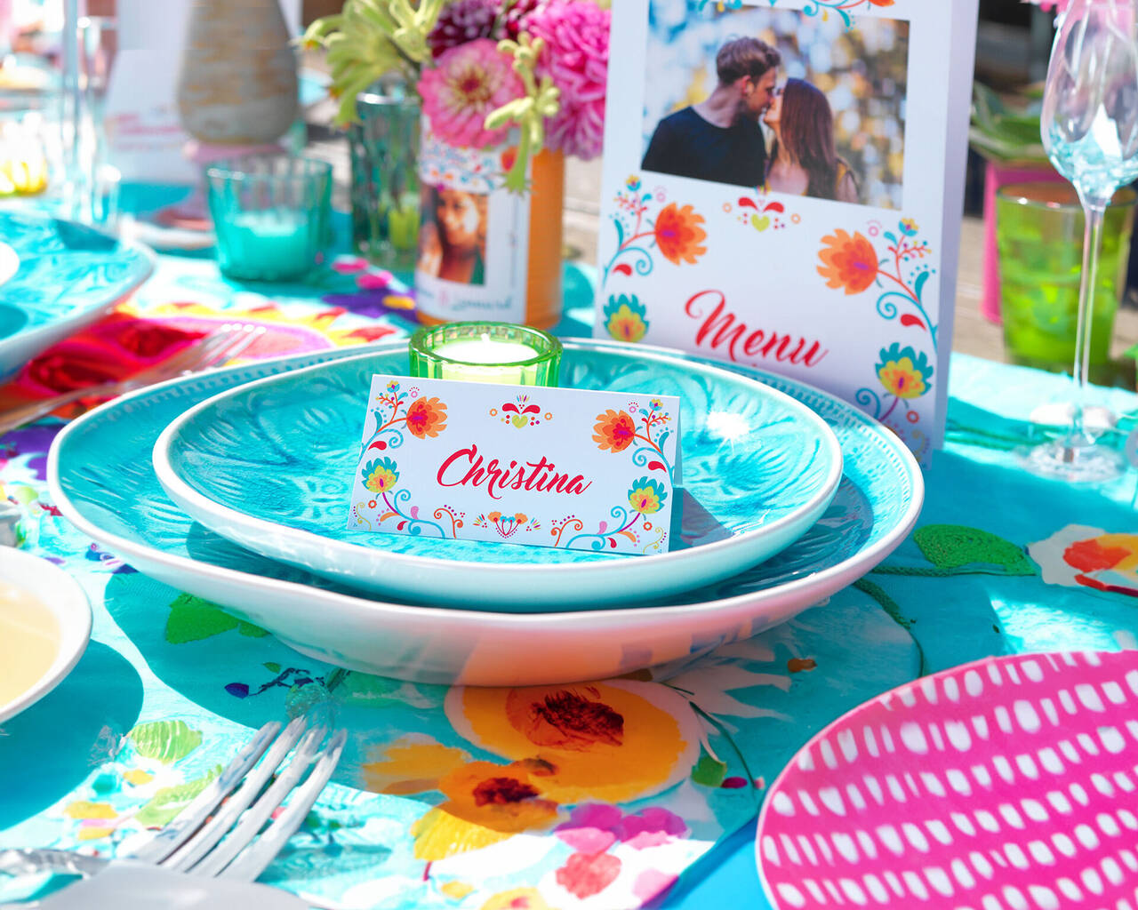 Colorfully decorated table with dishes and place card.