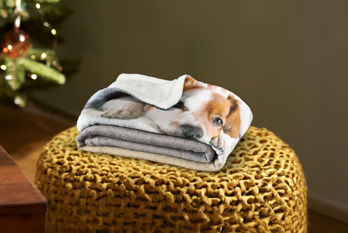 Folded towels on a stool with a dog design