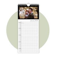 A wall calendar with a picture of father and child in nature. January 2024 is visible.
