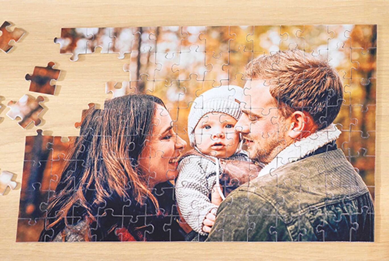 A puzzle featuring a loving family picture in an autumn park, being crafted together.