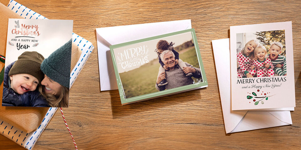 Three beautiful Christmas cards on a table, radiating joy and festive spirit.