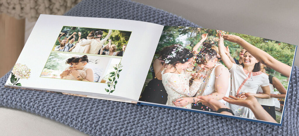 Two pages of a CEWE photo book filled with wedding pictures and colorful confetti moments.