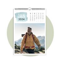 Man with sunglasses and yellow jacket hiking in the mountains.
