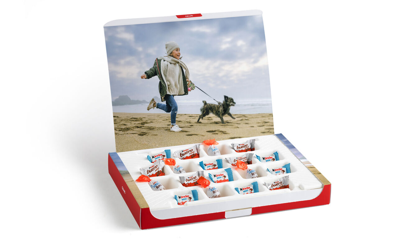 A happy child plays with a dog on the beach.
