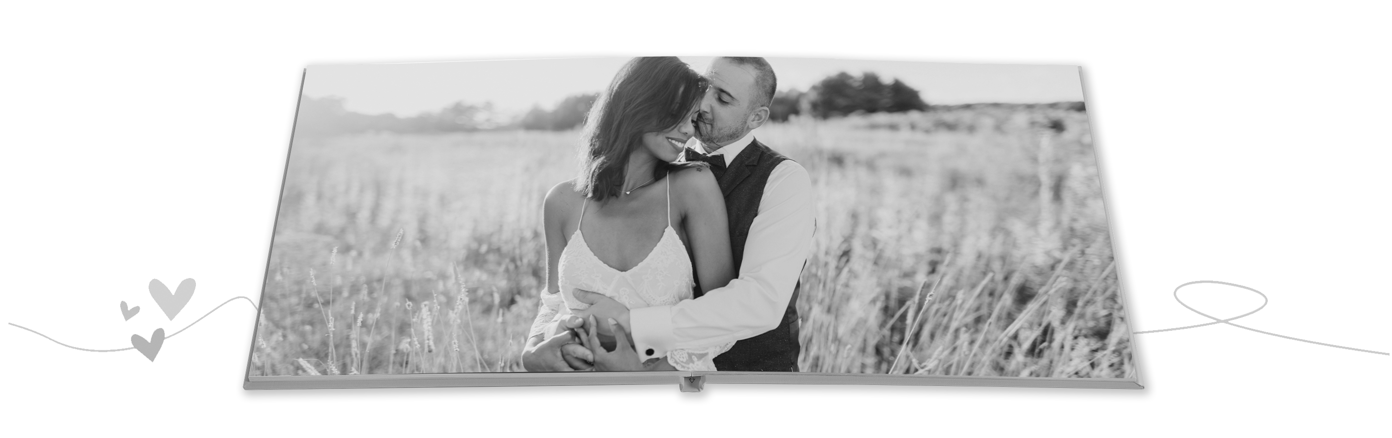 A happy couple embraces in a field while enjoying a shared moment